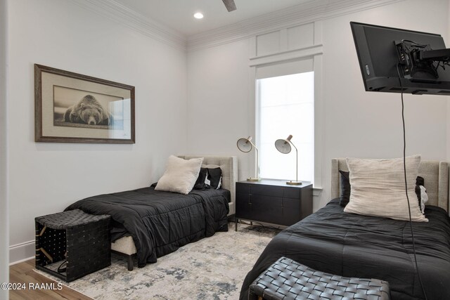 bedroom featuring ornamental molding, ceiling fan, and hardwood / wood-style flooring