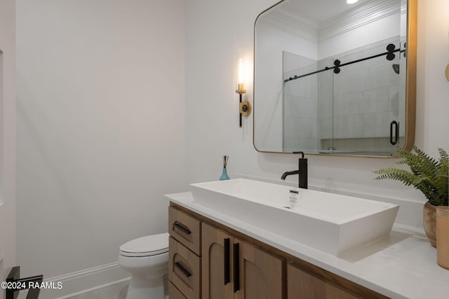 bathroom featuring ornamental molding, vanity, toilet, and an enclosed shower