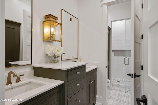 bathroom featuring tile patterned floors, a shower with shower door, vanity, and toilet