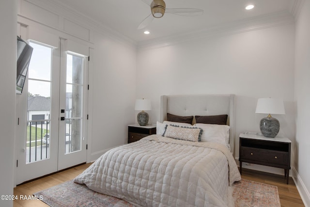 bedroom with light wood-type flooring, access to outside, crown molding, ceiling fan, and french doors