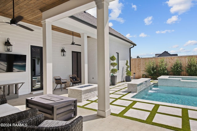 view of pool with ceiling fan, an in ground hot tub, a patio area, pool water feature, and an outdoor living space with a fire pit