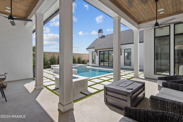 view of swimming pool with ceiling fan, an in ground hot tub, and a patio area