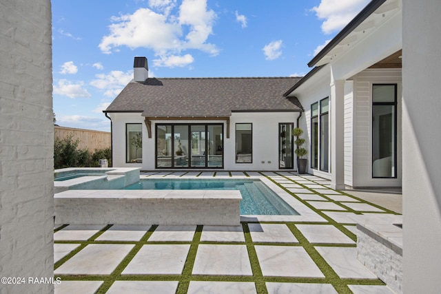 view of pool featuring an in ground hot tub and a patio area