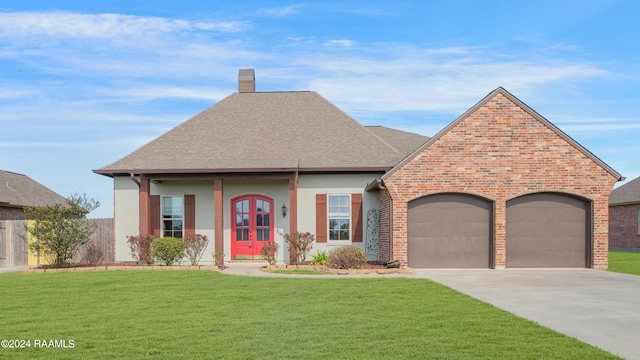 view of front of property featuring a garage, a front lawn, and french doors