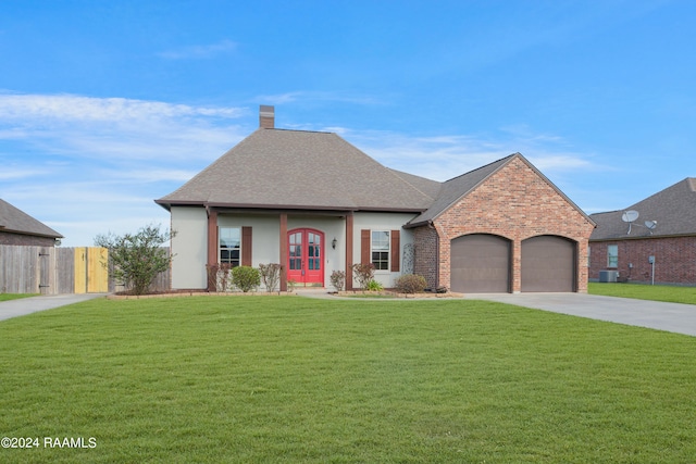 view of front of house featuring a garage, a front lawn, and central air condition unit