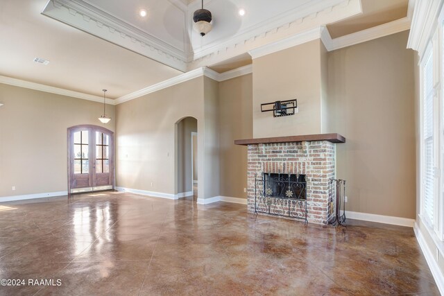 unfurnished living room with a high ceiling, ornamental molding, ceiling fan, and a brick fireplace