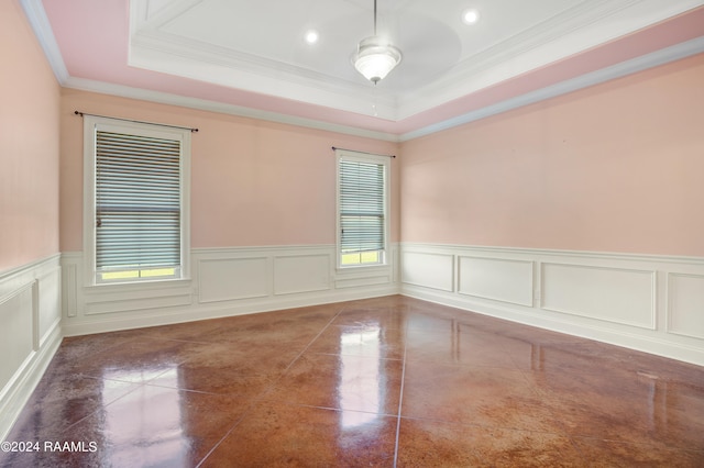 unfurnished room featuring ceiling fan, a raised ceiling, and ornamental molding