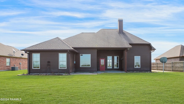 back of property featuring a yard, a patio, and central AC