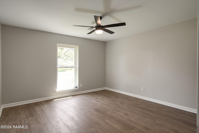 spare room featuring dark hardwood / wood-style floors and ceiling fan