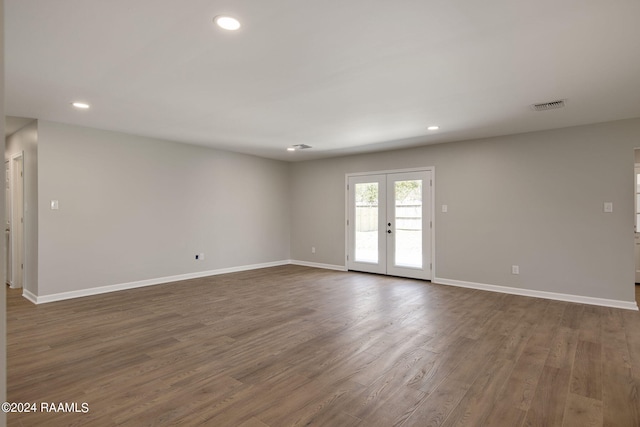 empty room featuring french doors and dark hardwood / wood-style flooring