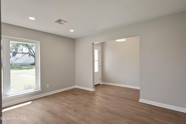 spare room with hardwood / wood-style flooring and a wealth of natural light