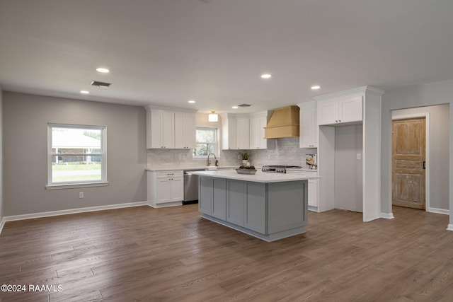 kitchen featuring white cabinets, plenty of natural light, and a kitchen island