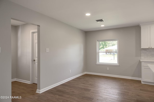 unfurnished dining area with dark hardwood / wood-style floors