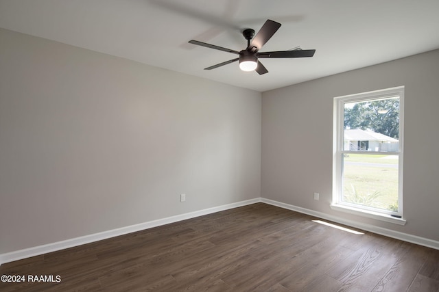 spare room with ceiling fan and dark wood-type flooring