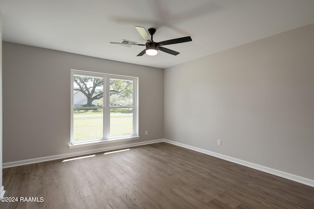 empty room with ceiling fan and dark hardwood / wood-style floors