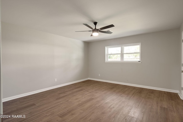 unfurnished room featuring dark hardwood / wood-style floors and ceiling fan