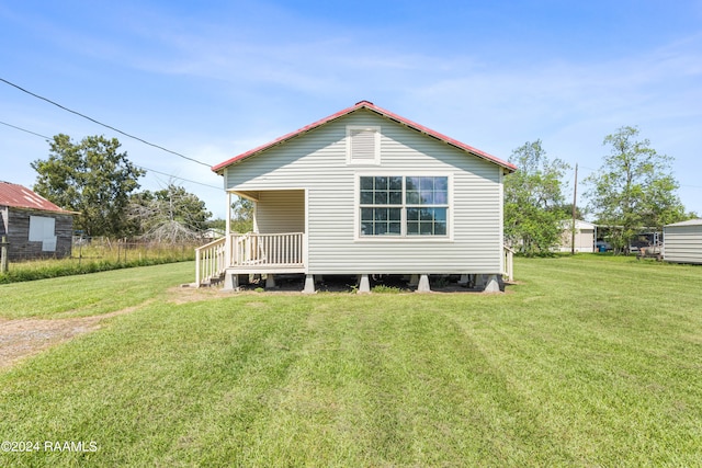 back of property featuring a lawn