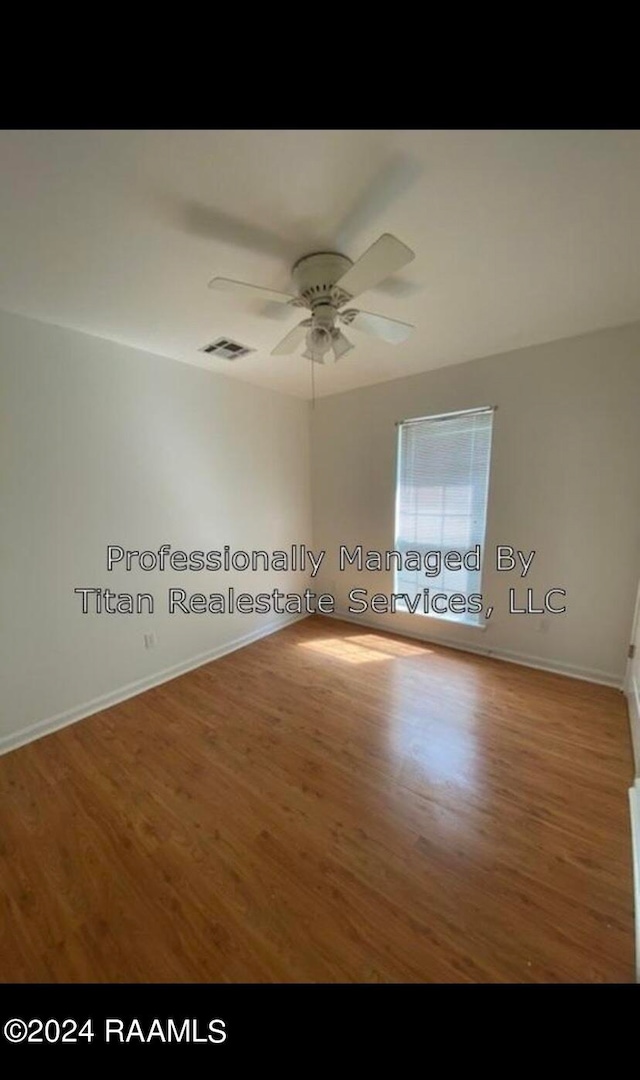 spare room featuring ceiling fan and hardwood / wood-style flooring