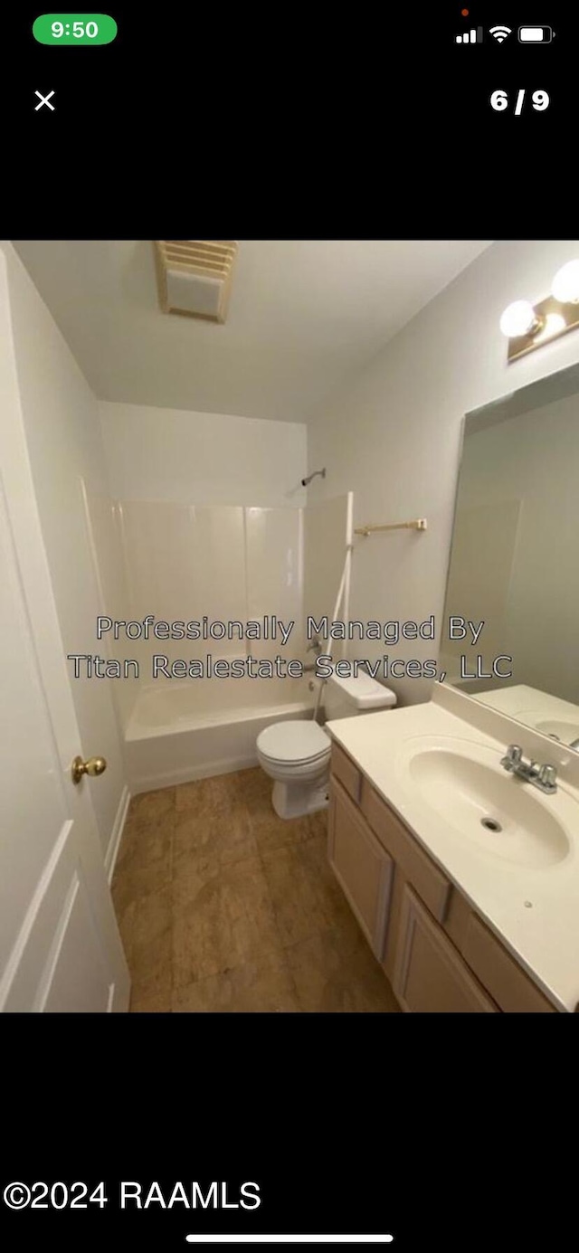 full bathroom with tub / shower combination, vanity, and toilet