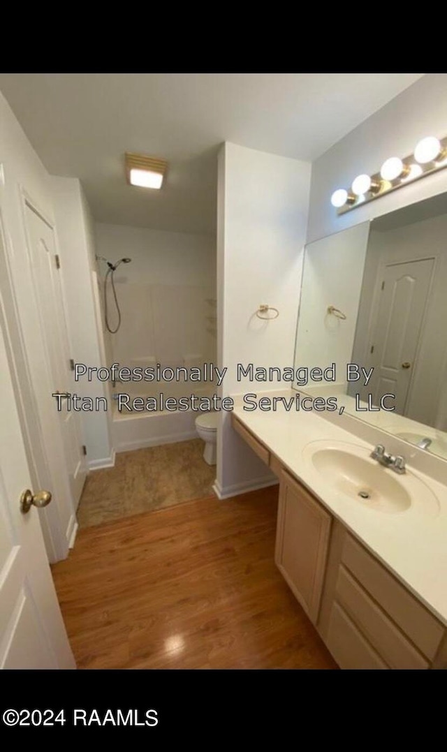 full bathroom featuring bathtub / shower combination, hardwood / wood-style floors, vanity, and toilet