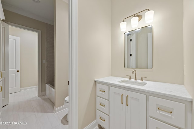 full bath with baseboards, toilet, and vanity