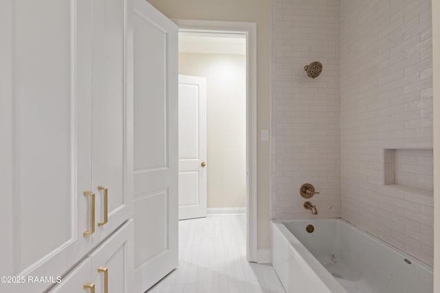 bathroom featuring shower / bathing tub combination and baseboards