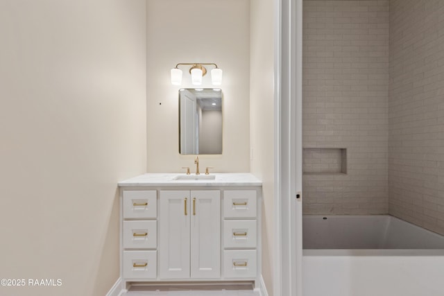 full bath with baseboards, a tub to relax in, and vanity