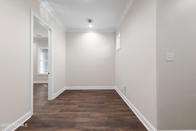 spare room with crown molding, recessed lighting, baseboards, dark wood finished floors, and visible vents