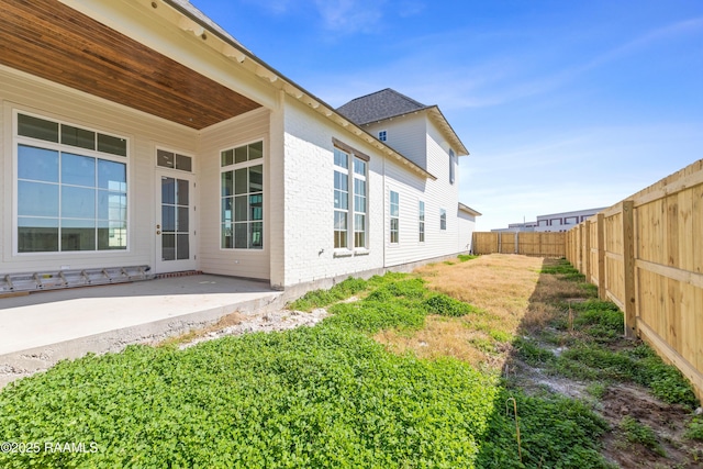 view of yard with a fenced backyard and a patio