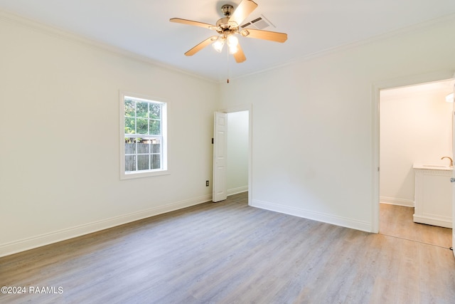 empty room featuring ornamental molding, ceiling fan, and light hardwood / wood-style flooring