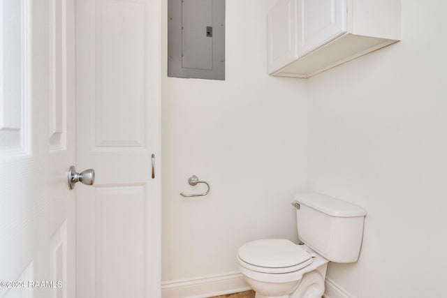 bathroom with electric panel and toilet