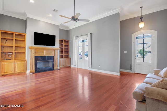 living room with ceiling fan, hardwood / wood-style flooring, and ornamental molding