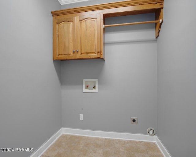 laundry room with light tile patterned floors, electric dryer hookup, washer hookup, and cabinets