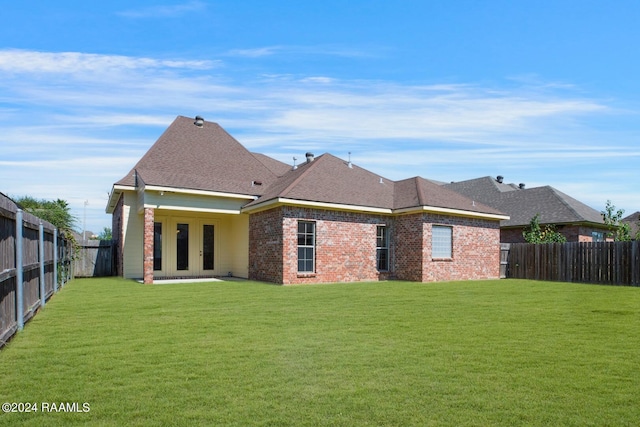 back of house with a lawn