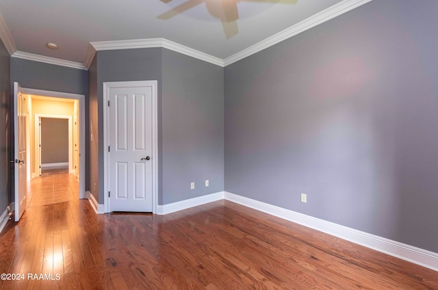 unfurnished bedroom with ceiling fan, crown molding, and hardwood / wood-style floors