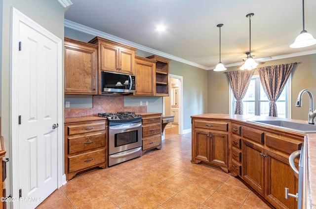 kitchen with appliances with stainless steel finishes, hanging light fixtures, and crown molding