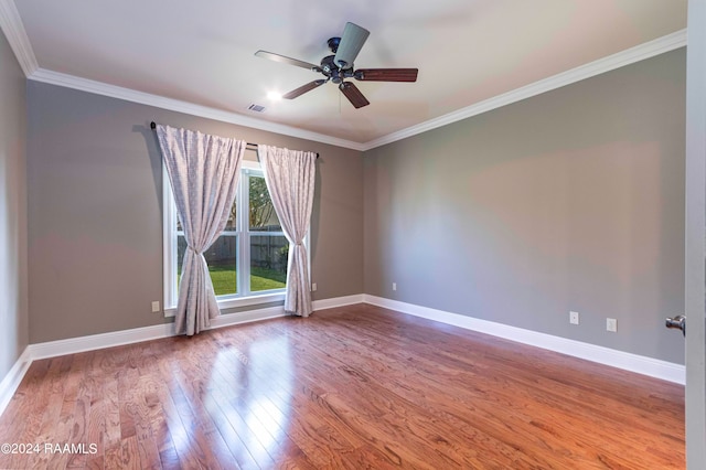 empty room featuring wood-type flooring, ornamental molding, and ceiling fan