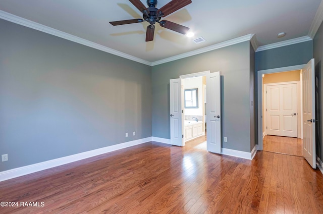 unfurnished bedroom featuring ceiling fan, ensuite bath, crown molding, and light hardwood / wood-style floors