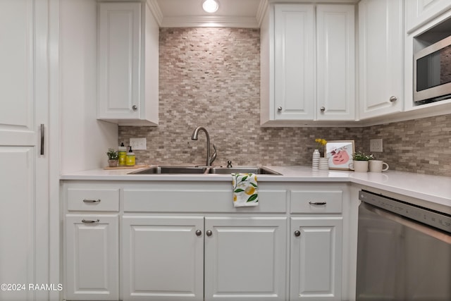 kitchen featuring appliances with stainless steel finishes, white cabinets, and sink