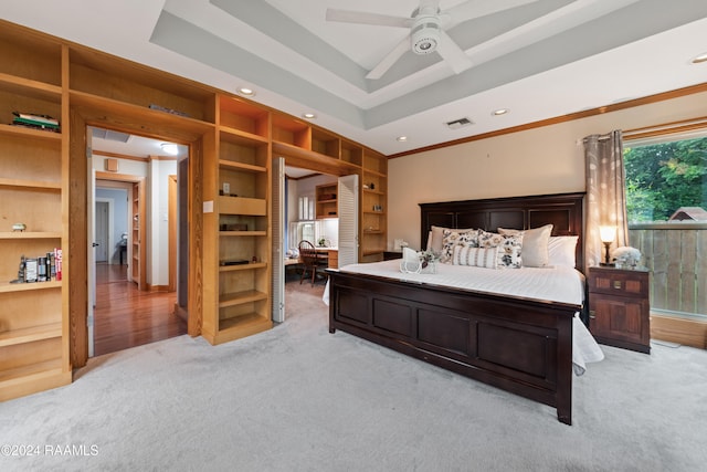 bedroom with light carpet, crown molding, a raised ceiling, and ceiling fan