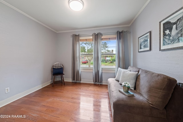 living area featuring hardwood / wood-style floors and crown molding