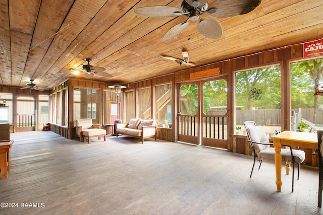 sunroom featuring wood ceiling, a wealth of natural light, and ceiling fan