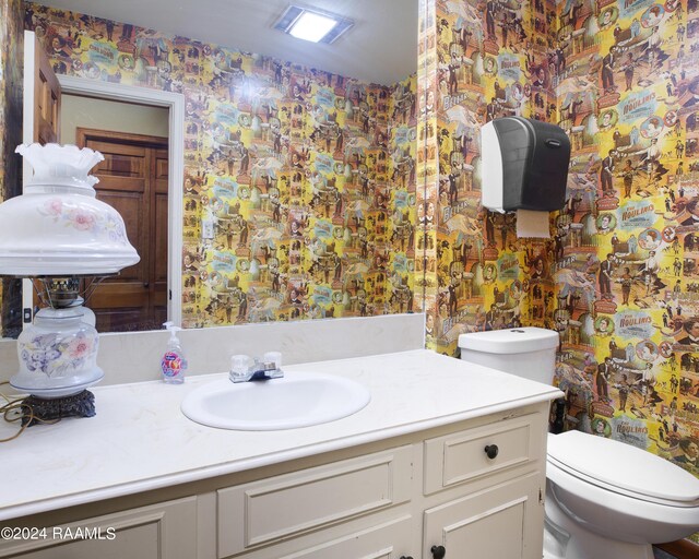 bathroom featuring vanity and toilet