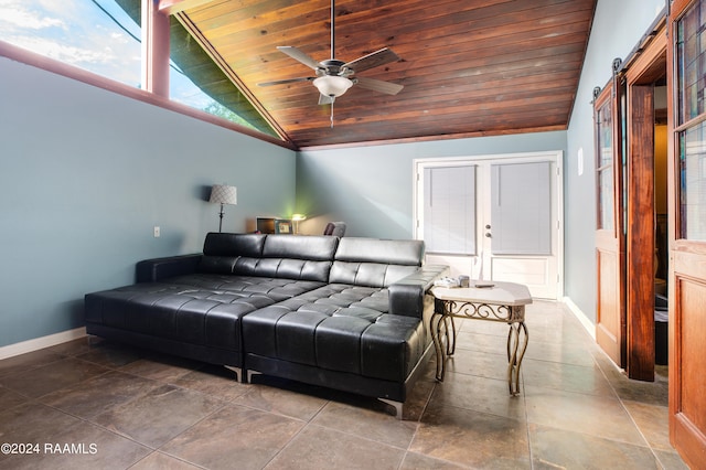 living room featuring lofted ceiling, ceiling fan, wooden ceiling, and a barn door