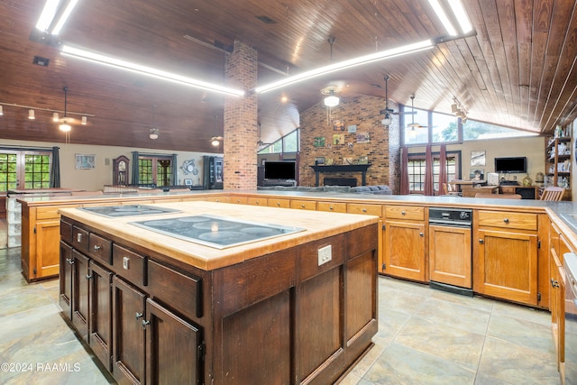 kitchen featuring stovetop, kitchen peninsula, wooden ceiling, and a healthy amount of sunlight