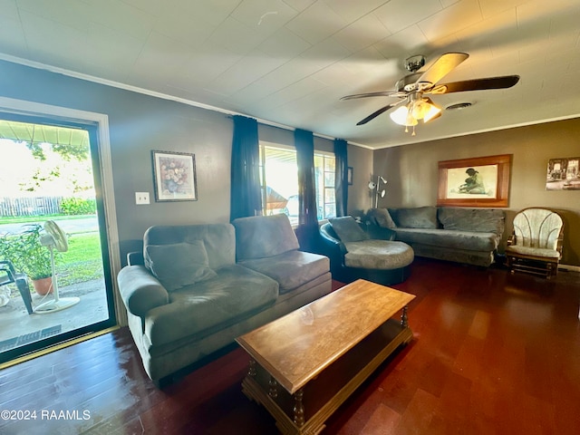 living room with ceiling fan, dark hardwood / wood-style floors, ornamental molding, and a healthy amount of sunlight