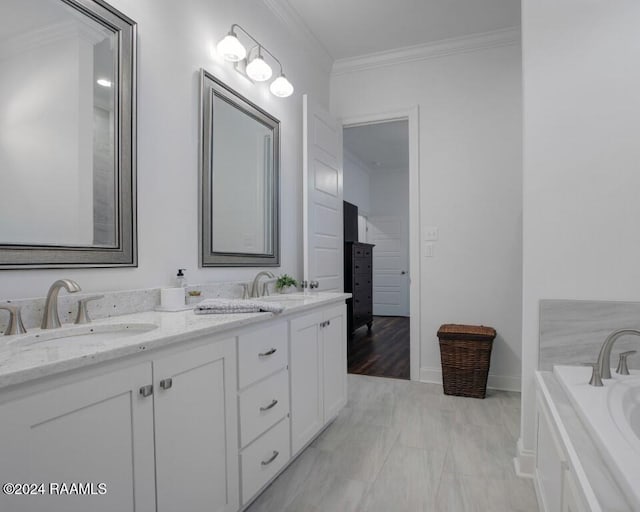 bathroom with ornamental molding, a tub to relax in, and vanity