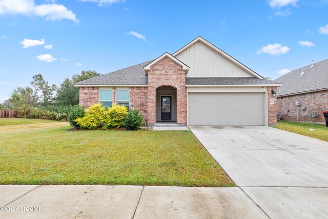 view of front of house featuring a garage and a front lawn