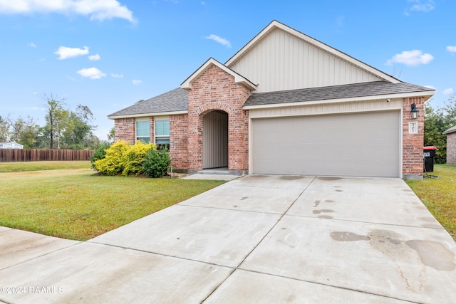 view of front of house featuring a garage and a front lawn