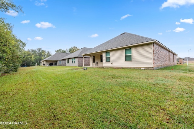 back of house with a yard